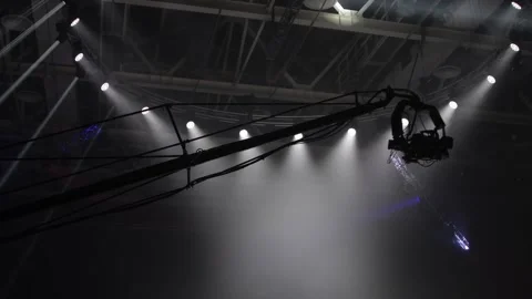 The camera on the operator's crane flies against the background of bright rays Stock Footage 125534203