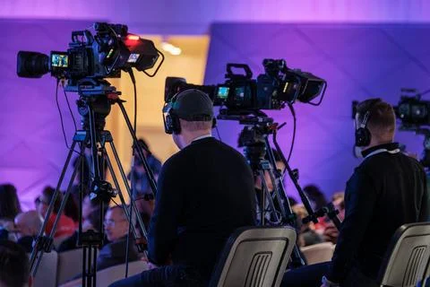 Camera operators filming live event production with professional video cameras Stock Photos
