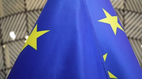 Camera orbits around the European Union flag inside a government building Vídeo Stock 325479516