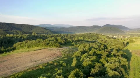 Camera over the forest, among the mountains at sunset Stock Footage 158232377