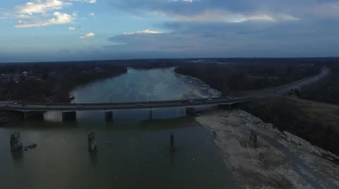 Camera over river moving away from bridge long shot Stock Footage 60036588