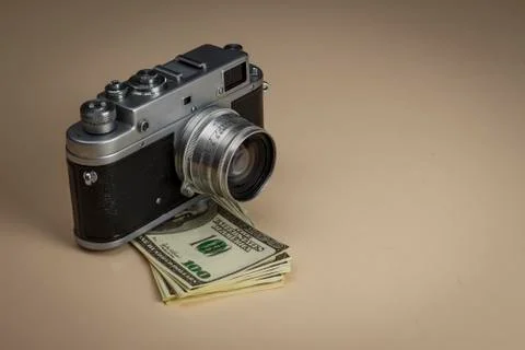 The camera on a pack of dollars is on the table Stock Photos