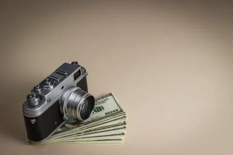 The camera on a pack of dollars is on the table Stock Photos