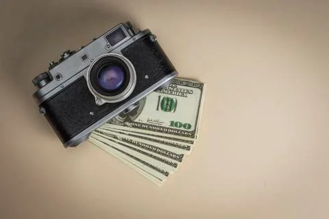 The camera on a pack of dollars is on the table Stock Photos