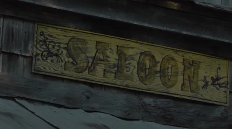 Camera Pan Across Old West Ghost Town Saloon Sign. Stock-Footage 34330302