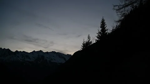 Camera pan across snowy mountains at sunset Video stock 233916643