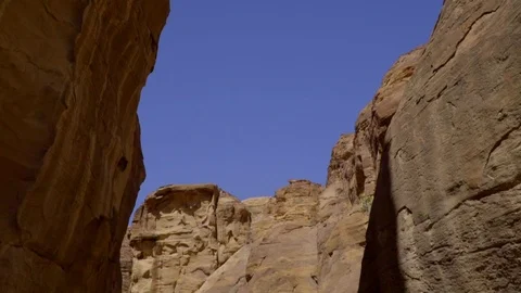 Camera pan of blue sky down to the mountain rock Stock Footage 103330555
