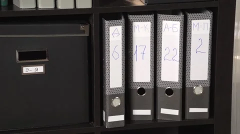 Camera pan on boxes in office cupboard Stock Footage 60814877