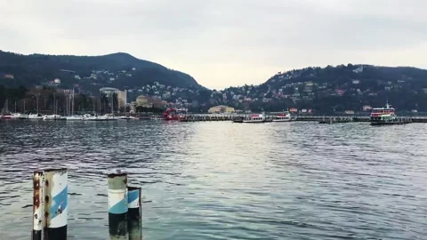 A camera pan of lake di como with road and cars and hotels and boats Stock Footage 247160064