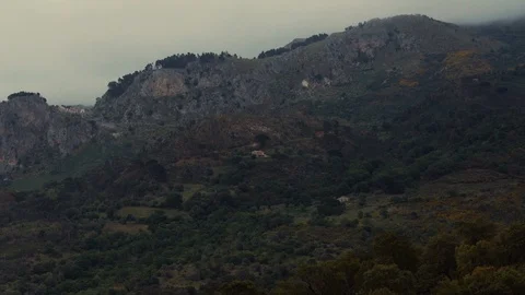 Camera pan left over a small town at the edge of a cliff Stock Footage 88711391