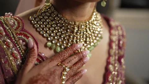 Camera pan over beautiful Gold necklace pakistani bridal getting ready her Stock Footage 278477374
