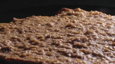 Camera pan over the oatmeal and lean cheese pie on a black plate Stock-Footage 166356447