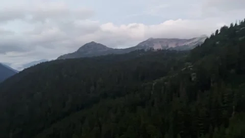 A camera pan a spectacular view of mountains and asphalt road with cars Stock Footage 320148649