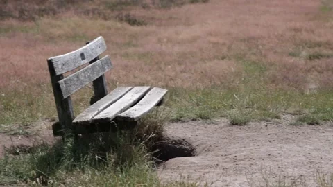 Camera pan on Wooden bench on a field Stock Footage 201597610
