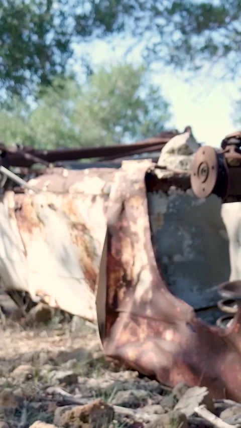 Camera panning across abandoned car wreck Stock Footage 294963786