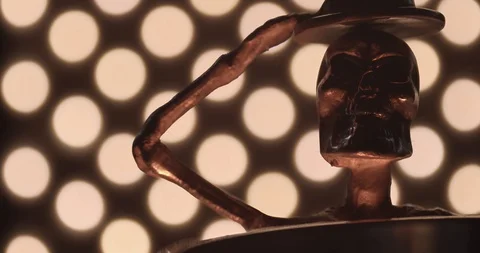 Camera panning across a metallic skeleton with a illuminated by warm light. Stock Footage 117351069