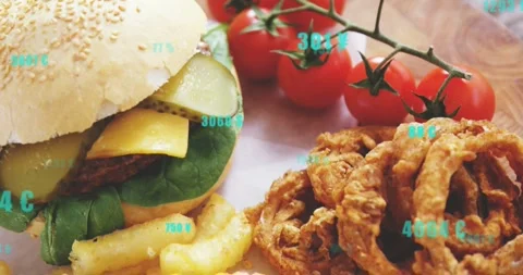 Camera panning across plated burger and fries, turquoise numbers updating to Stock Footage 331570991
