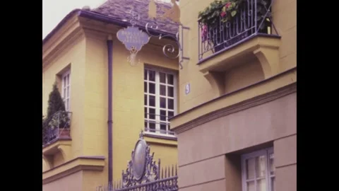 Camera panning across yellow building facade in paris Stock Footage 291050758