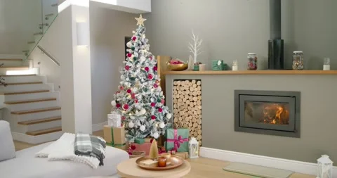 Camera is panning and zooming to flocked Christmas tree as fireplace is Stock Footage 342067885