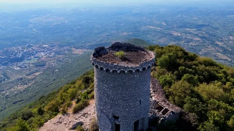 Camera panning around an old stone tower on a mountain top Video stock 285262353