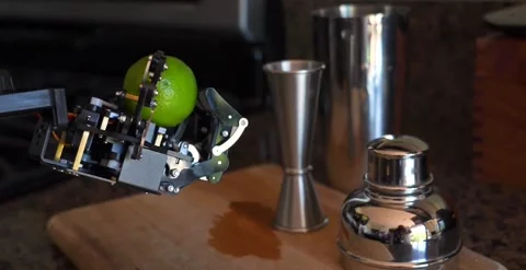 Camera Panning Of A Bartending Robotic Hand Holding A Lemon Stock Footage 248090152