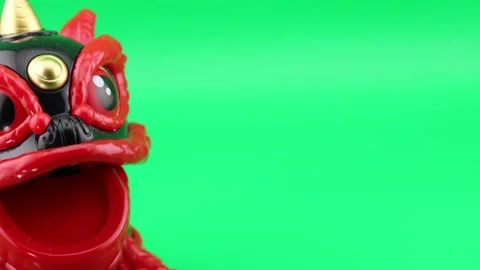 Camera panning from Chinese lion bobblehead to green screen background Stock Footage 337703712