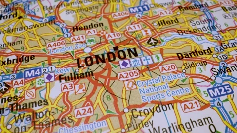 Camera panning close up on a map focusing on motorways heading into London Stock Footage 341752370