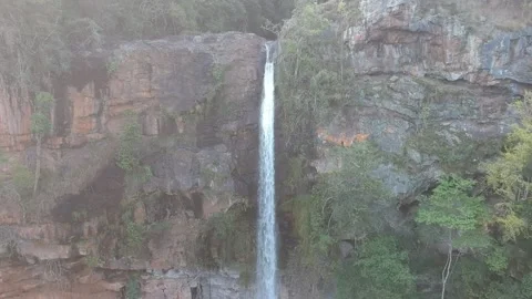 Camera panning down on a long thin waterfall Lone Creek falls to a natural r Stock Footage 167111575