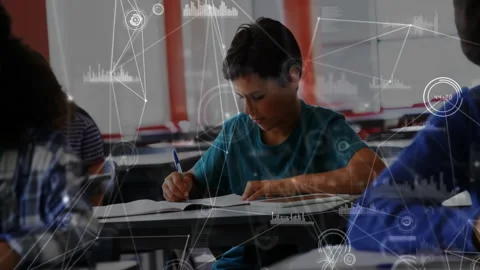 Camera panning focusing on boy writing notes in classroom with pulsing data Stock Footage 312712376