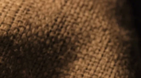 Camera panning onto a hand running through and lifting beans coffee beans Vidéo 33216555