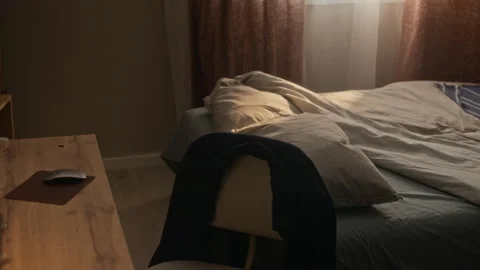 Camera Panning from Home Office Desk to Unmade Bed in Morning Stock Footage 338337895