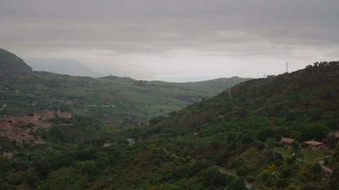 Camera Panning left over a small town between mountains Stock Footage 88683976