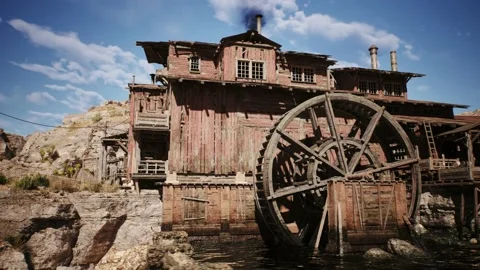 Camera is panning next to an old western lumber mill building in a west town Stock Footage 236396286