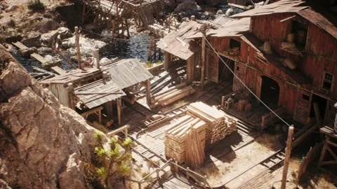 Camera is panning by an old western lumber mill building in a west town village Stock Footage 236396089