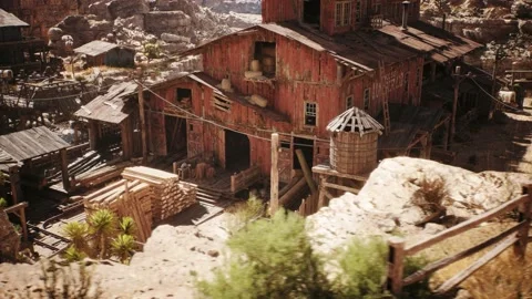 Camera is panning by an old western lumber mill building in a west town village Stock Footage 236396542