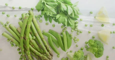 Camera panning over asparagus snap peas broccoli celery peas in plastic bag Stock Footage 331567927
