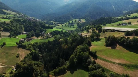 Camera panning over beautiful green valley with houses Stock Footage 283292397