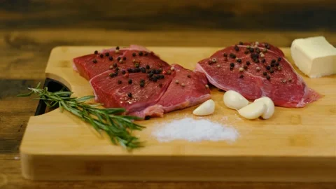 Camera panning over beef steak and cooking ingredients Video stock 188540652
