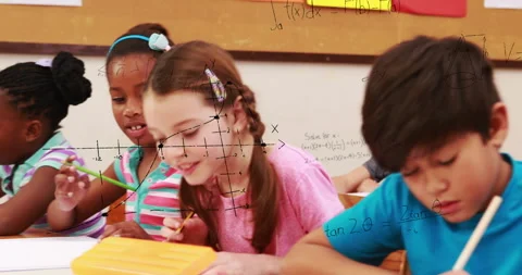 Camera panning over boy writing revealing peers writing with math graphs solving Stock Footage 315864495