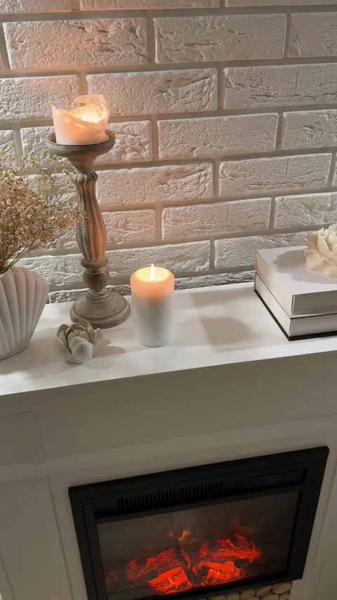 Camera panning over candles, dried flowers and decor on fireplace mantel Stock Footage 346084432