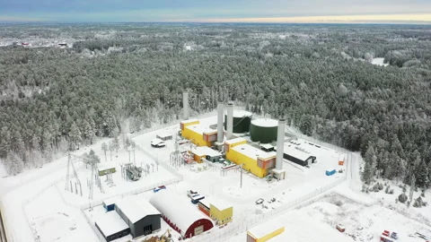 Camera panning over coal power plant surrounded by snowy forest, aerial view Stock Footage 289006997