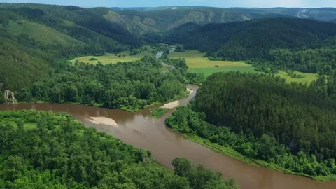 Camera panning over confluence of two rivers in scenic valley Видео 301396280