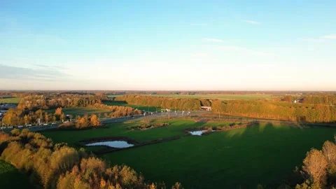 Camera panning over highway interchange surrounded by autumn forest Stock Footage 293158024