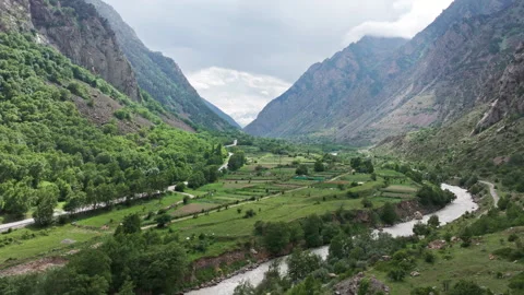 Camera panning over mountain valley river and fields Stock Footage 289661029