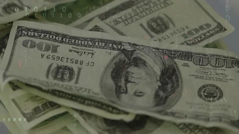 Camera panning over scattered 100-dollar bills, code overlay appearing and Stock Footage 329470852