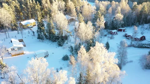 Camera panning over small village covered in fresh snow, aerial view Stock Footage 289006657