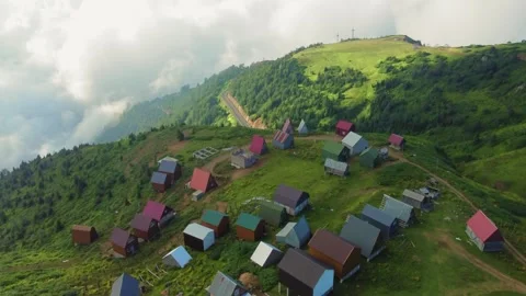 Camera panning over small village nestled in mountain valley Stock Footage 292804239