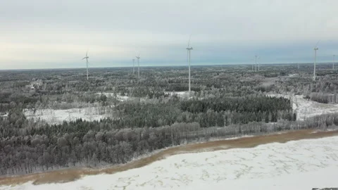 Camera panning over snowy landscape with wind turbines, aerial view Stock Footage 289006548
