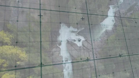 Camera panning over transparent panel, sliding calibration grid across waterfall Video stock 334115305