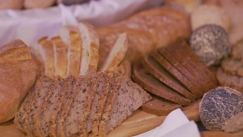 Camera panning past bread rolls in baskets on a table Stock Footage 143807218